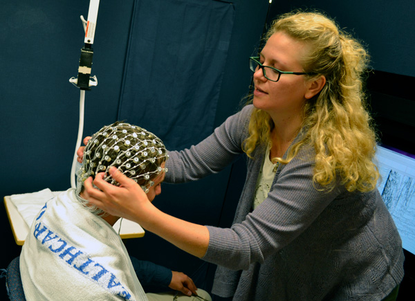 Photo in clinic of a Brain Imaging Core clinician working with a patient.