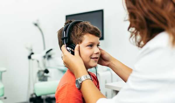 Photo of a child performing a hearing test.