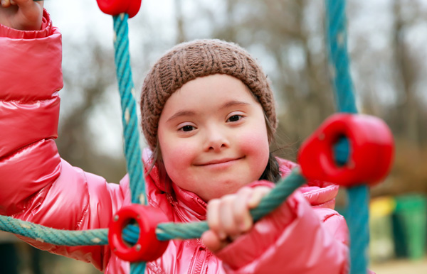Photo of a young girl playing on the playground.