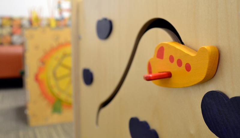 Photo of a toy airplane on a box in the children's play area in the IHDD Specialty Clinic lobby.
