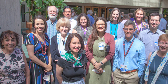 Photo of Genetic Medicine team standing in-front of UW Medicine.