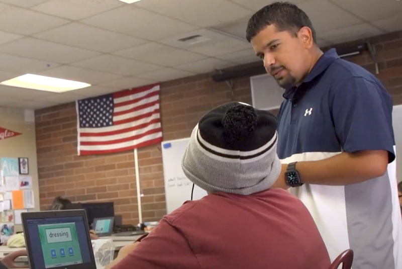 Video Screenshot: Teacher at Toppenish Middle School assisting a student.