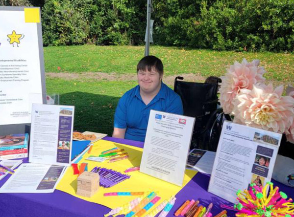 Photo: Grayson Hicks managing the information booth at the Buddy Walk. 