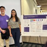 Photo of a moderator and trainee presenter at the 2023 Research Day event in South Campus Center at the University of Washington.