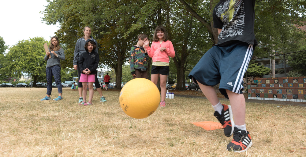 Photo: UW Autism Center's APEX Summer Camp campers playing kickball on a sunny day.