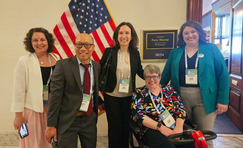 Photo: LEND Trainees and Faculty posing for a group photo in front of Patty Murray's office door.