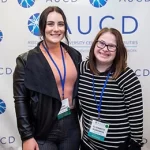 Photo of two smiling attendees at an AUCD Conference.