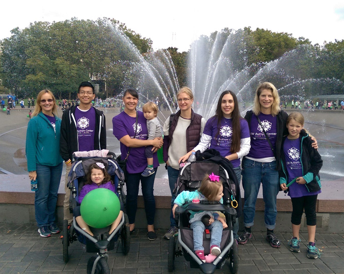 Photo: Team and family members from the UW Autism Center standing in front of the Seattle Center fountain.