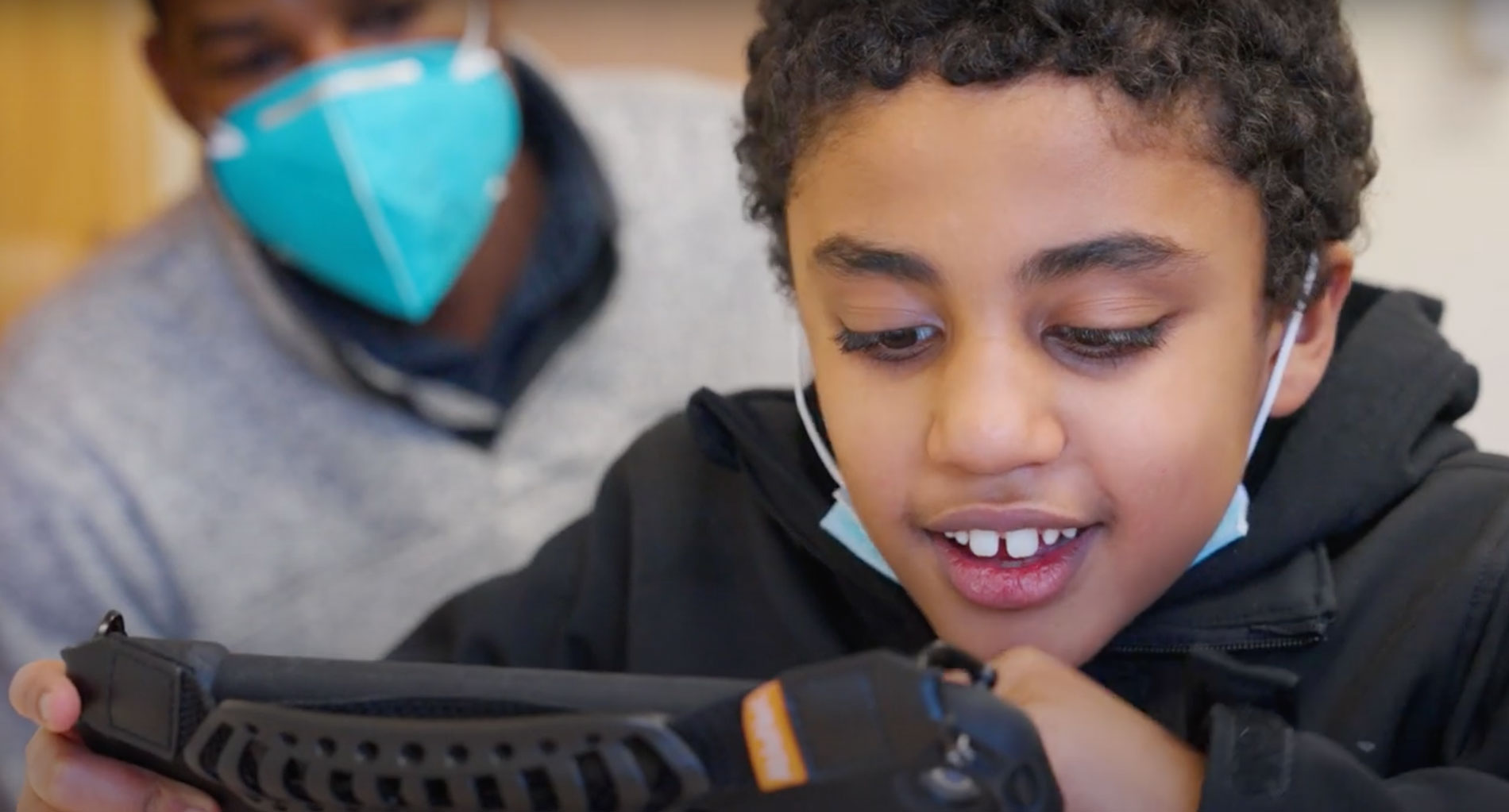 IHDD student using an assistive technology device.