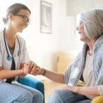 Doctor smiling at her smiling patient in a small clinic.