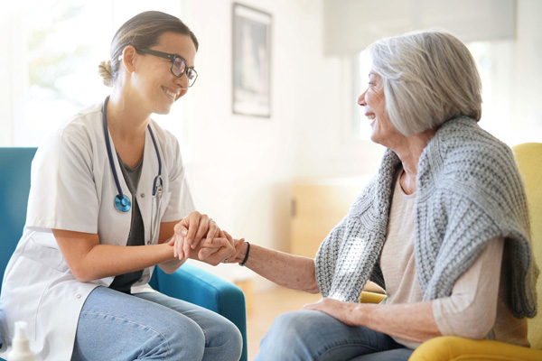 Doctor smiling at her smiling patient in a small clinic.