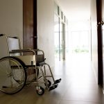 Empty wheelchair sitting outside a doctors office.