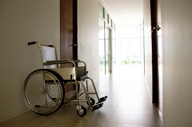Empty wheelchair sitting outside a doctors office.