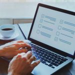 Person participating in a survey on a computer.