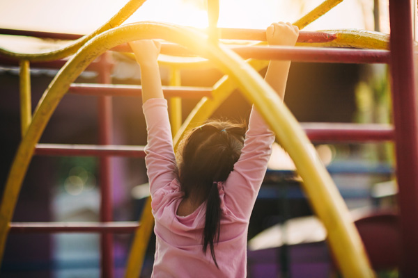 Young child playing on a playground.