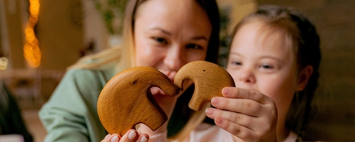 Photo of a child and parent holding a cookie together - Pexels Antoni Shkraba